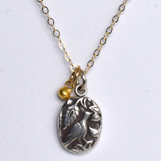 Handformed fine silver pendant with bronze bead